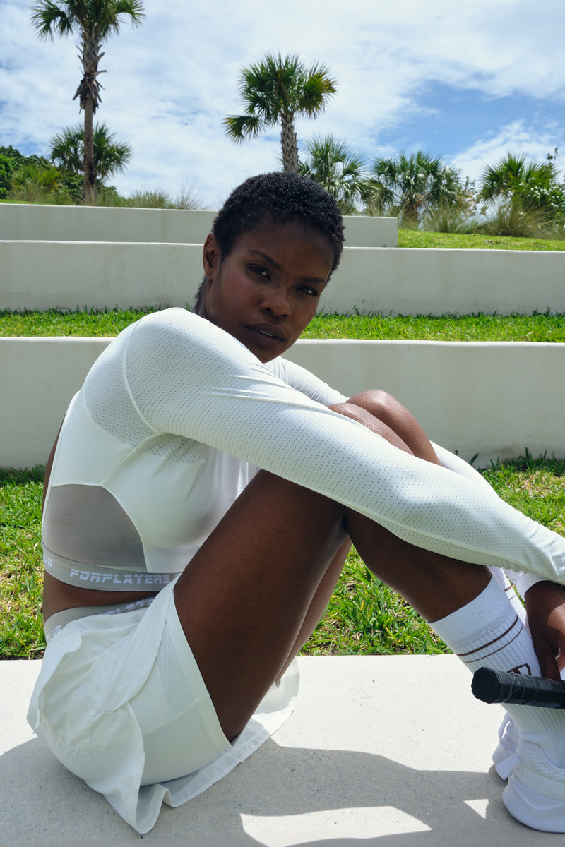 White open-back long sleeve tennis top