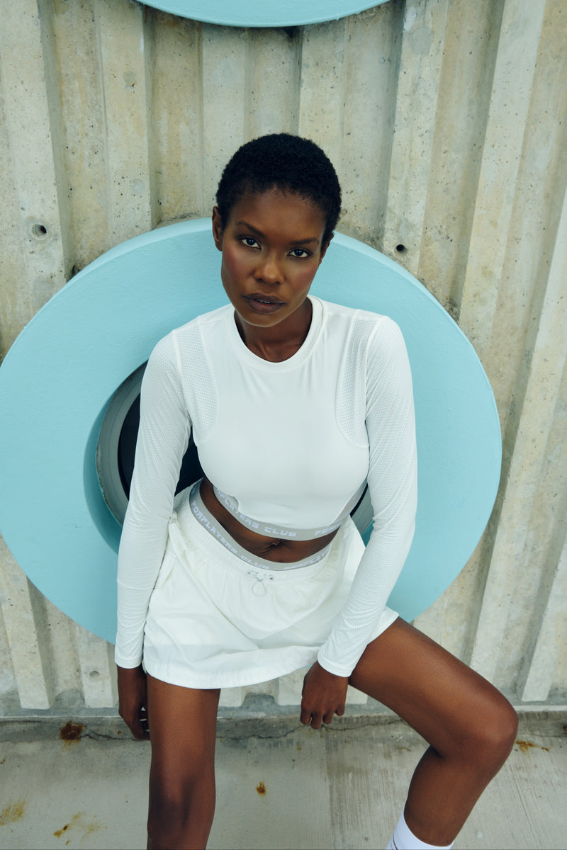 White open-back long sleeve tennis top